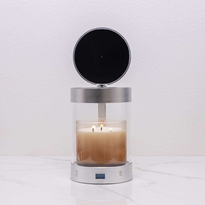 Silver ALEC holder with its lid open over a lit three-wick jar candle