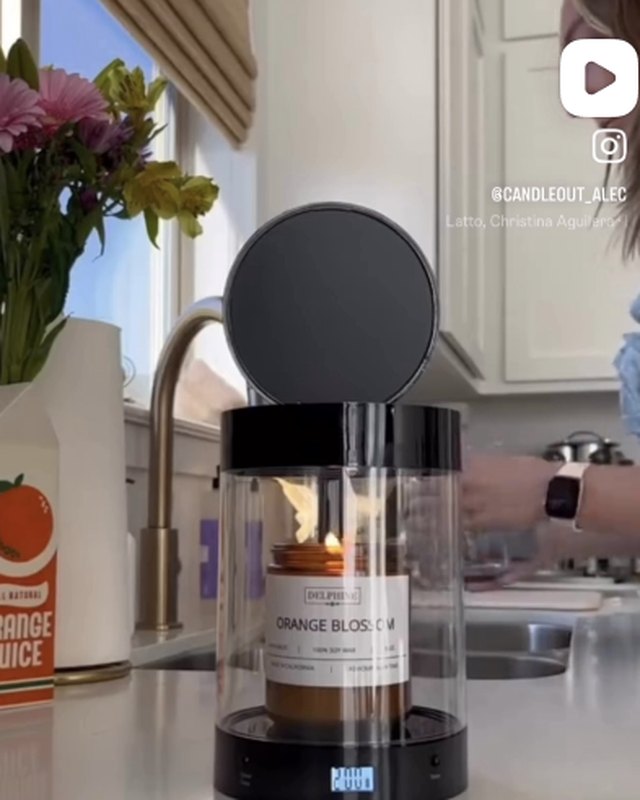 Black ALEC on a kitchen counter with a lit candle