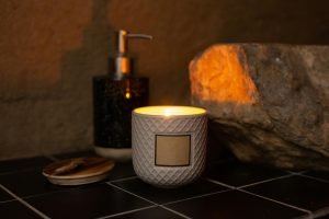 Lit candle in a white holder