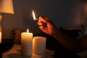side-view-hand-lighting-candle_23-2149477437